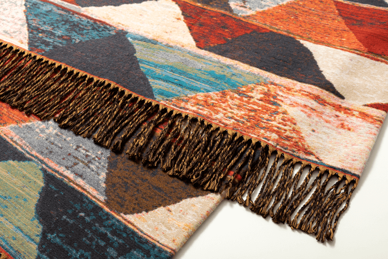 Vielseitiger Teppich mit buntem geometrischem Design und dekorativen Fransen