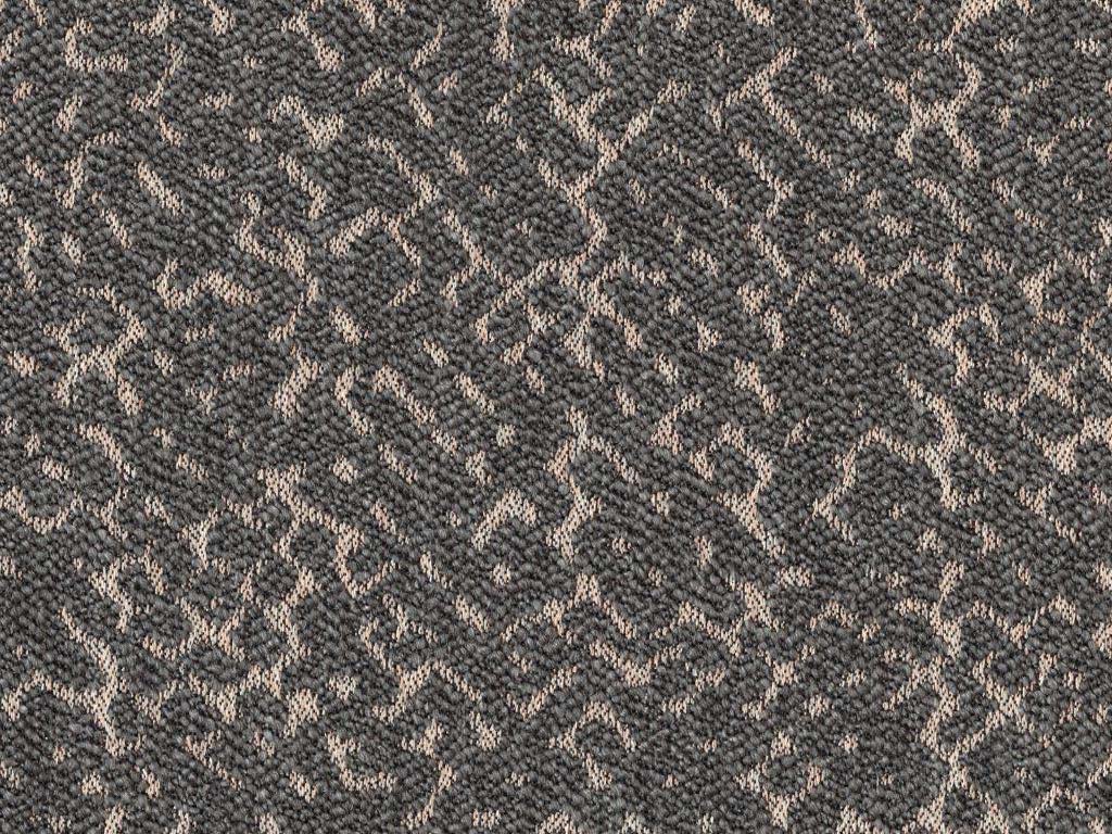 Detailaufnahme eines grauen Teppichs mit komplexem Design und texturierter Oberfläche