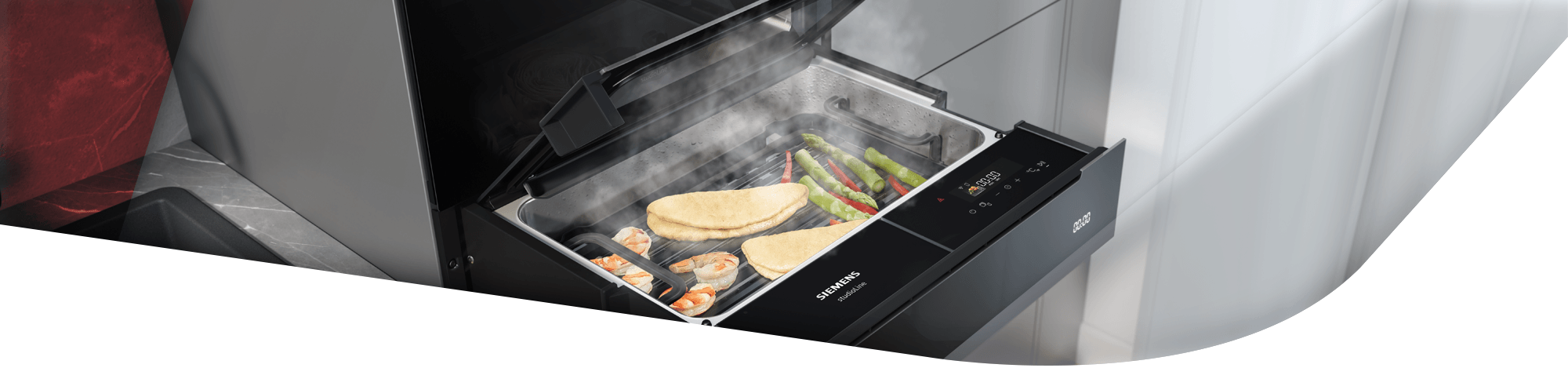 Stimmungsvoller Header einer geöffneten Dampfschublade, in der Fischfilets und grüner Spargel gleichzeitig unter sanftem Dampf garen.