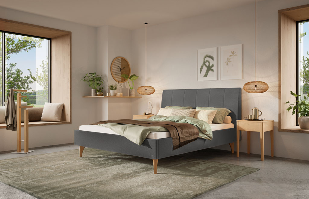 Nahaufnahme des grauen Kopfteils mit vertikaler Steppung eines Polsterbettes im gemütlichen Schlafzimmer (KI-generiert)
