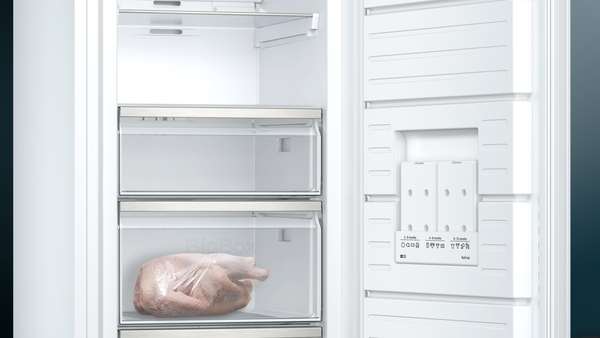 Offener Gefrierschrank mit einem gefrorenen Truthahn in der unteren Schublade