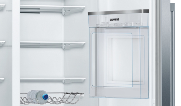 Ein geöffneter Siemens Kühlschrank mit Eiswürfelbereiter und einer Wasserflasche im Fach.