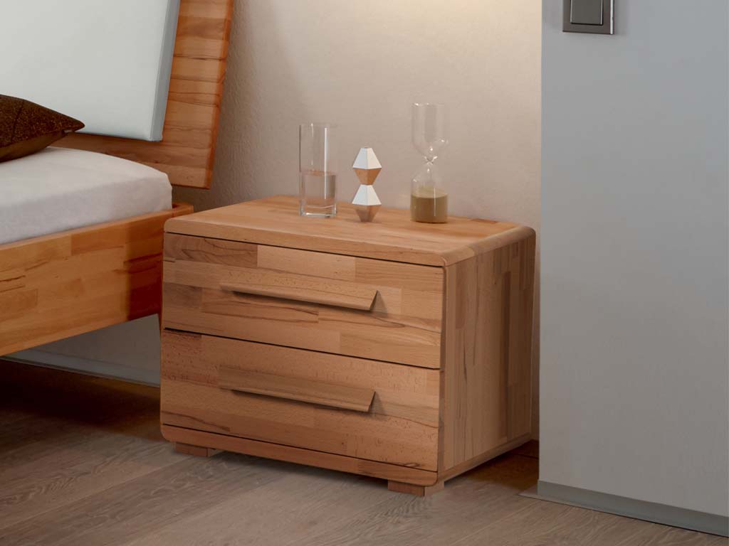 brauner Holznachttisch mit zwei schubladen in abgerundeter optik und markanten breiten holzgriffen stehende neber einem bett in einem modernen zimmer noma von hasena