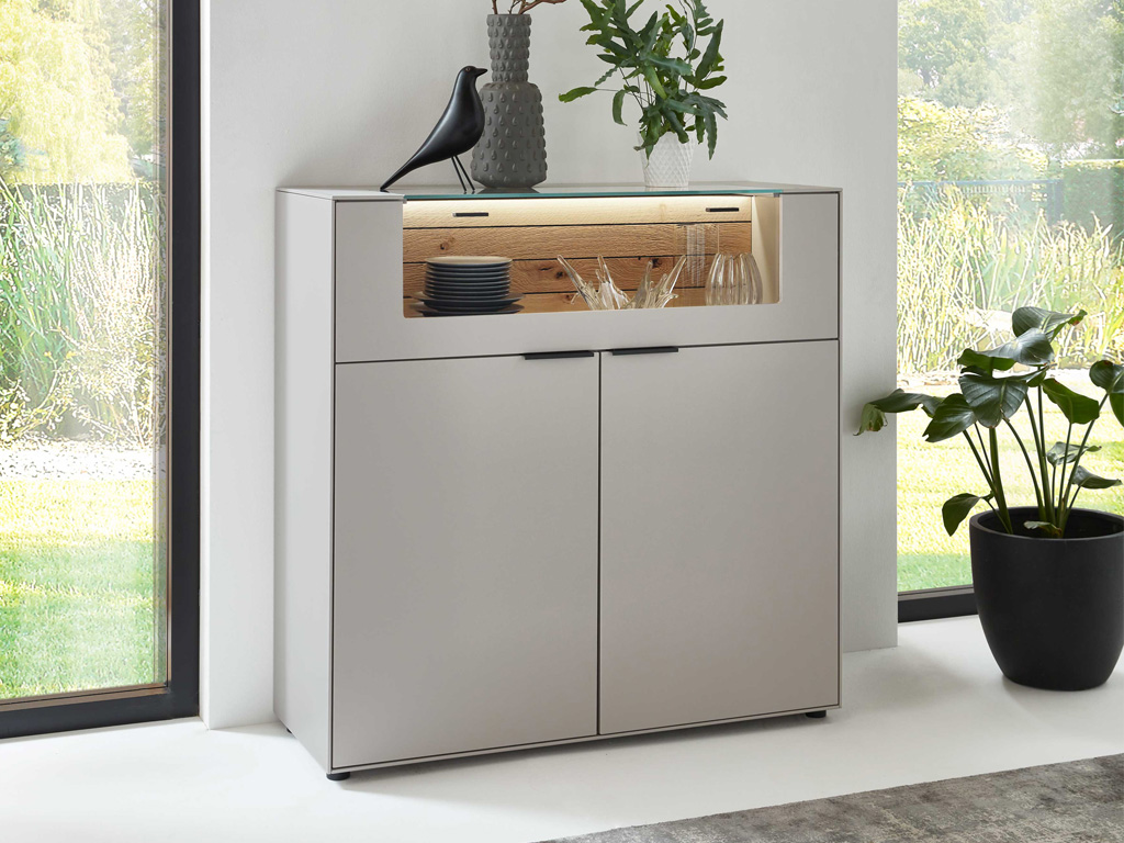 Wöstmann WM 2380 - Highboard | Type 3122 | B: 121,9 cm | konfigurierbar Eleganter Schrank mit Glasvitrine, dekoriert mit Vase, Vogelstatue und Pflanzen, in modernem Wohnzimmer