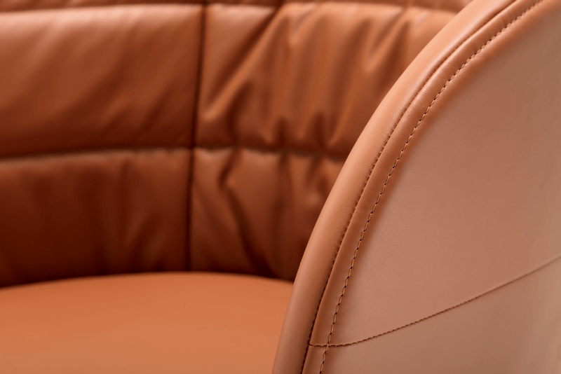 Detailansicht eines braunen Ledersessels mit fein gearbeiteten Nähten