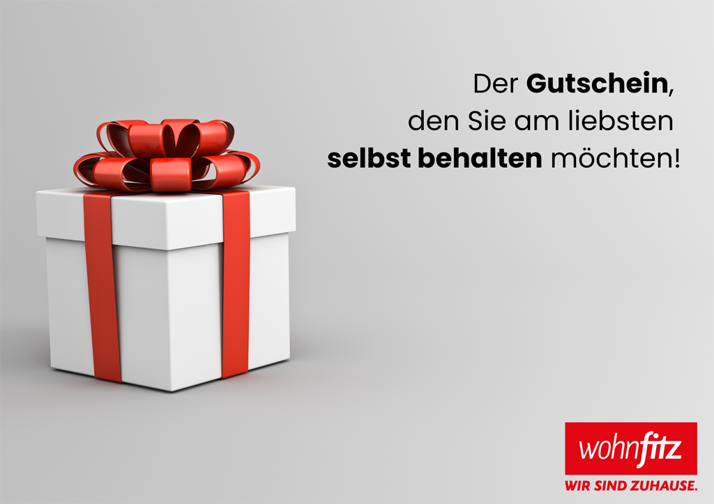 weißes Geschenk mit roter Schleife und Schriftzug "Der Gutoschein, den Sie am liebsten selbst behalten möchten!" 