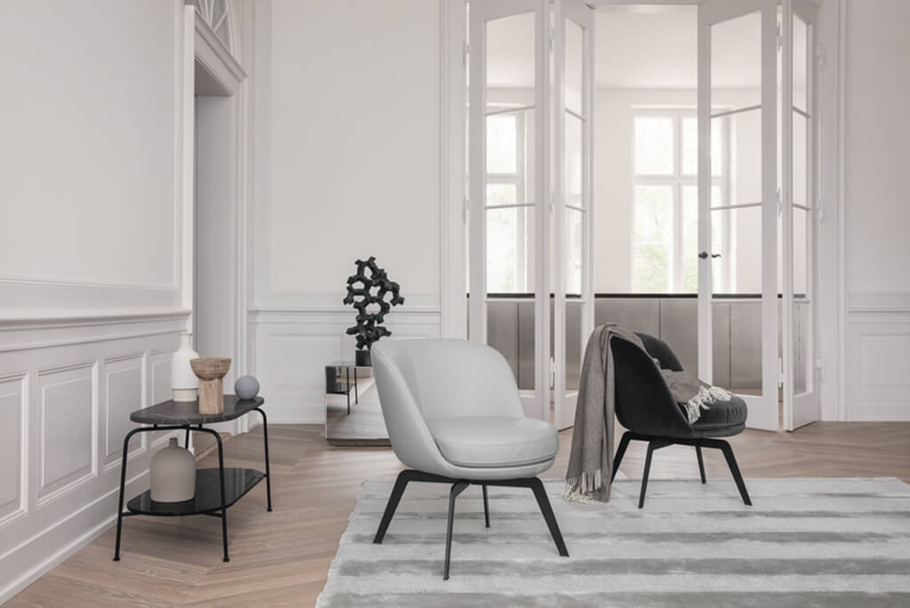 hellgrauer Sessel mit runder Sitzfläche und schwarzem Fußgestell