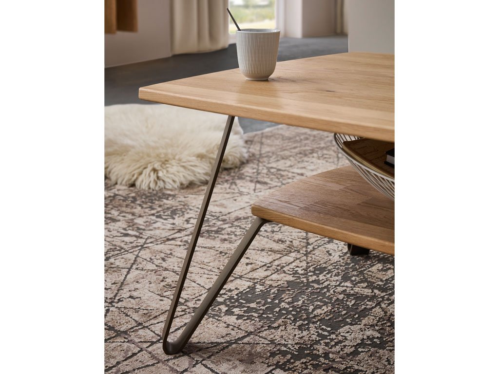 Detailaufnahme eines modernen Couchtisches aus Holz mit Metallgestell und einer Ablage stilvoll dekoriert in einem modernen Zimmer