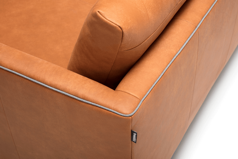 Bildausschnitt eines orangenenSofas mit weißer Umrandung. 