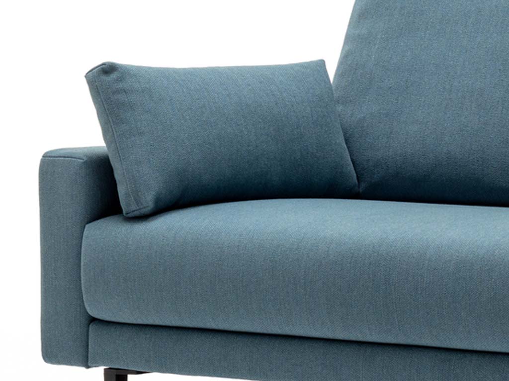 freistil Rolf Benz 170 - Seitenteilkissen | 56 x 26 cm Nahaufnahme eines modernen blauen Sofas mit einem Kissen auf der Armlehne