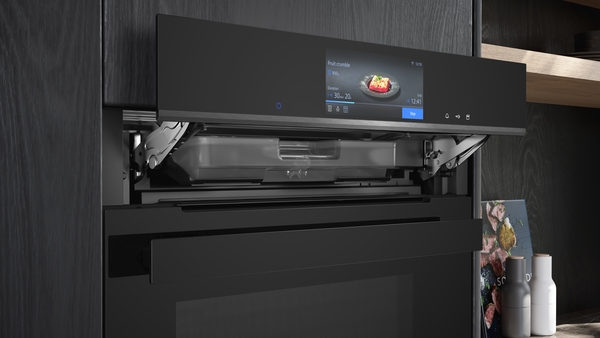 Geöffnete Einbau-Mikrowelle mit digitalem Touchscreen-Display in einer modernen Küche