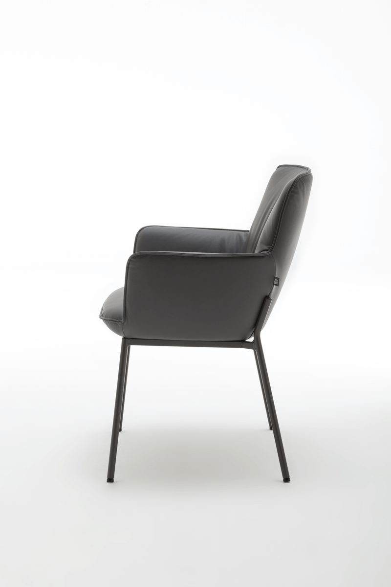 Seitliche Ansicht eines modernen Sessels mit schwarzer Lederpolsterung und filigranem Metallgestell