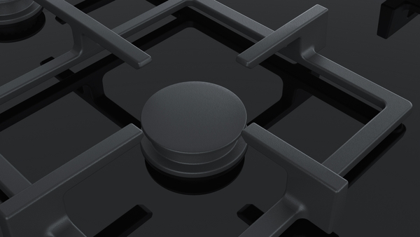 Nahaufnahme eines modernen Gasherds mit stilvollem Brenner und robusten gusseisernen Rosten