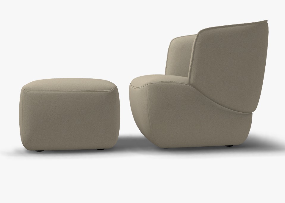 beiger designersessel mit hocker vor weißem hintergrund