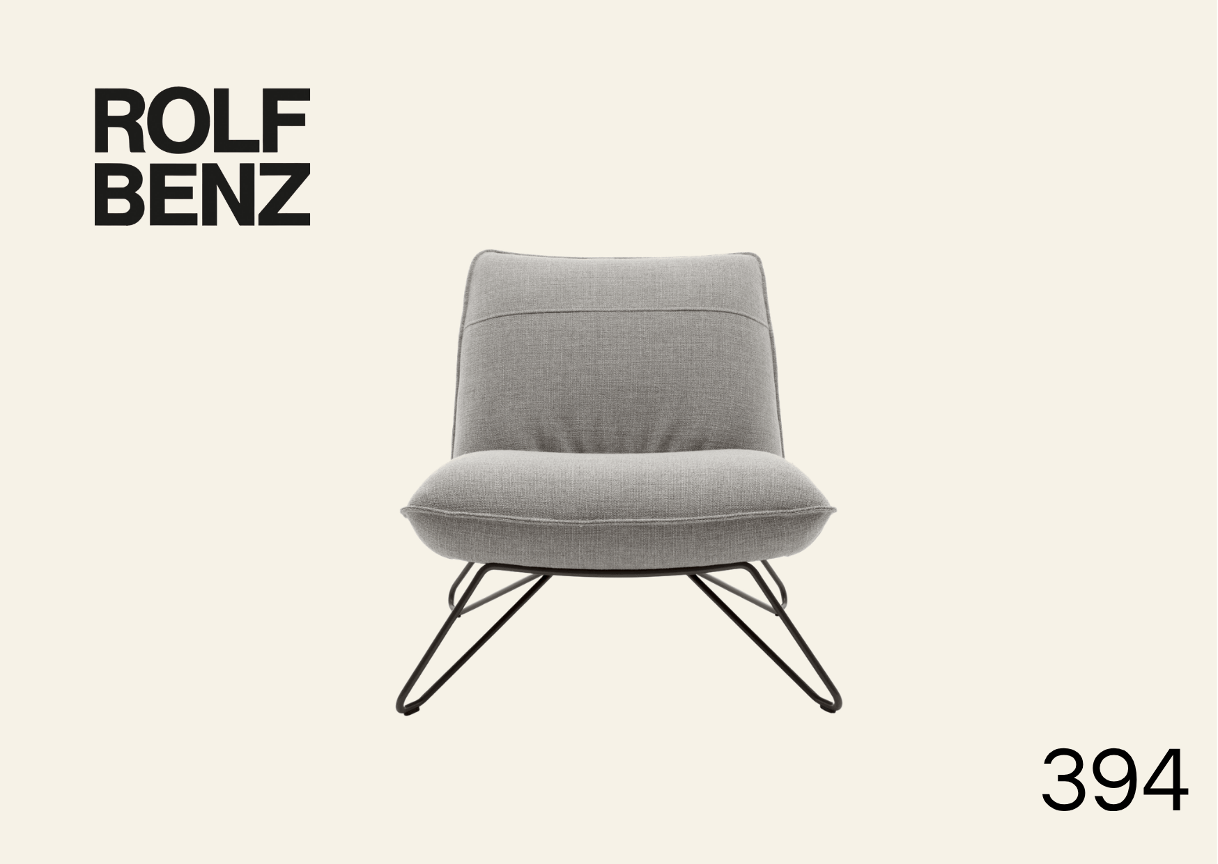 hellgrauer Polstersessel ohne Armlehnen. Aufschrift Bild: Rolf Benz 394.