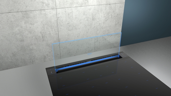 Elegante Dunstabzugshaube in einer modernen Küche, eingebettet in die Arbeitsfläche neben einer Betonwand.